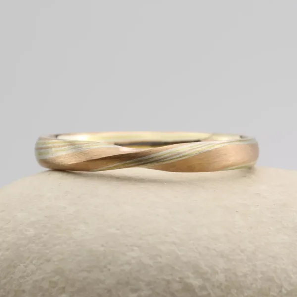 The Daiyana: Rose Gold Twist Mokume Gane Wedding Ring with Yellow Gold and Silver